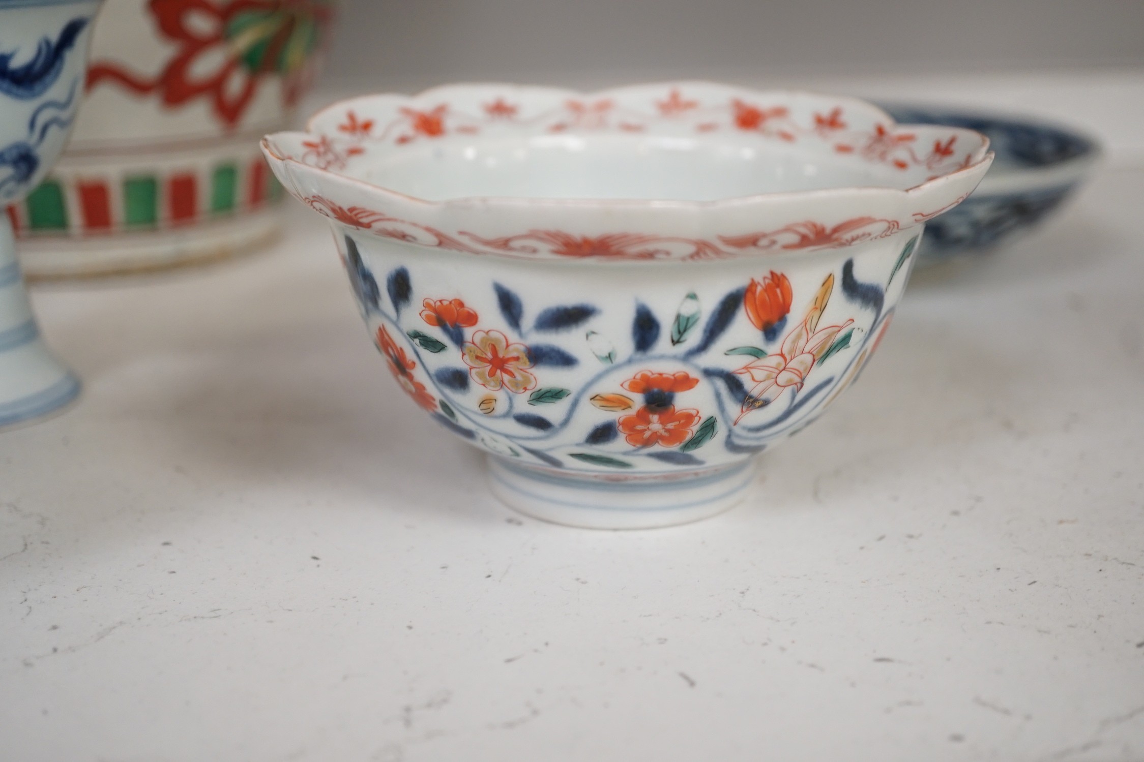 A Chinese wucai vase, two Imari bowls, a pair of Chinese blue and white dragon stem cups, Xuande marks, a Chinese blue and white dish, depicting a scholar on horseback, Xuande mark, a small green Chinese bowl, painted wi